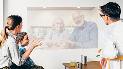 Family speaking to grandparents on screen